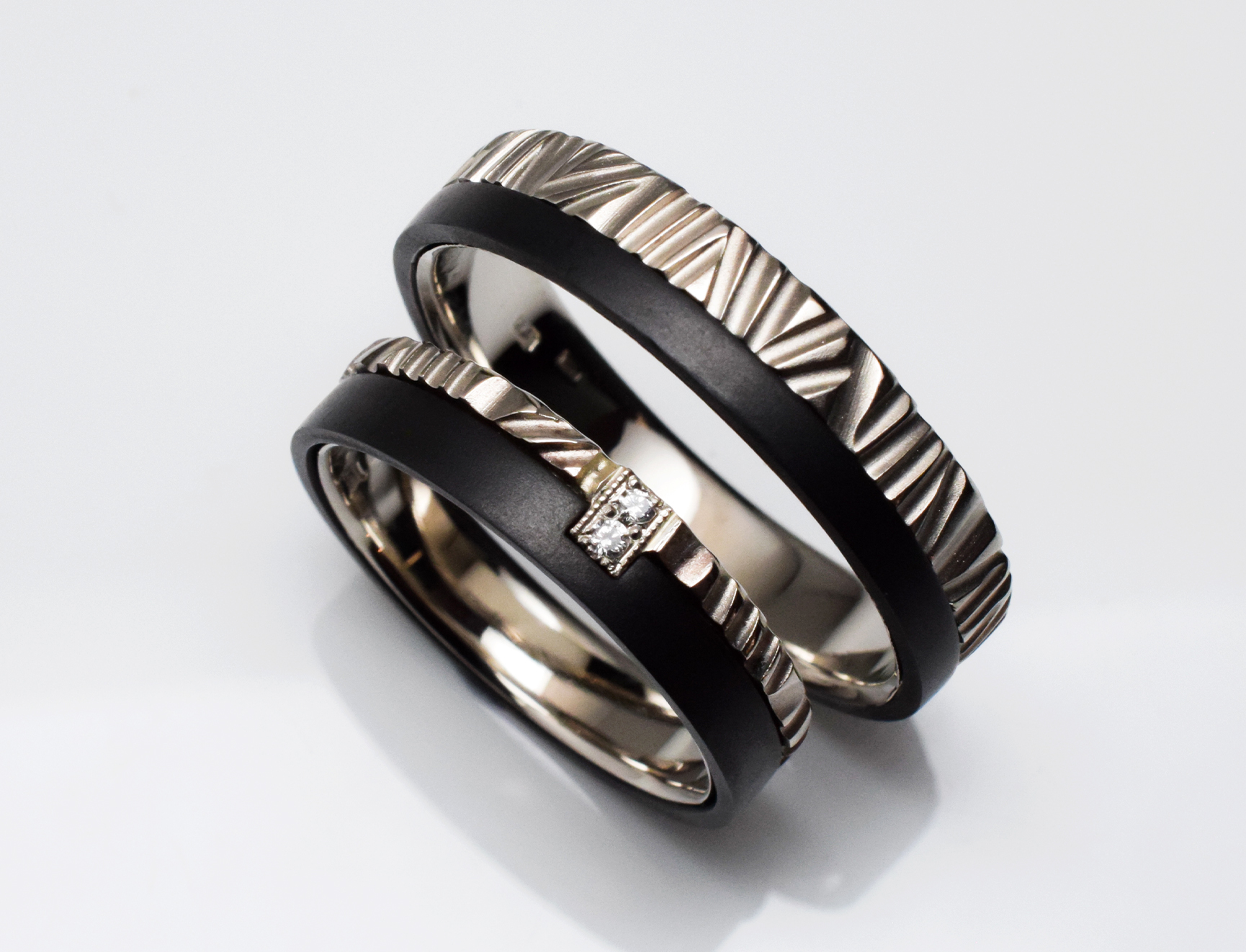 White gold wedding ring set with black band and diamonds