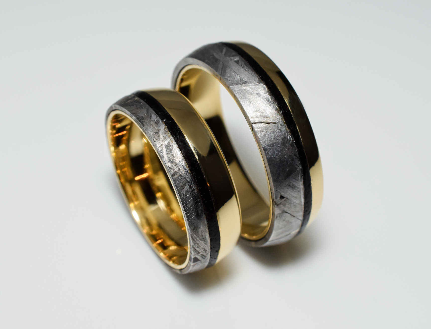 Gold wedding rings with meteorite