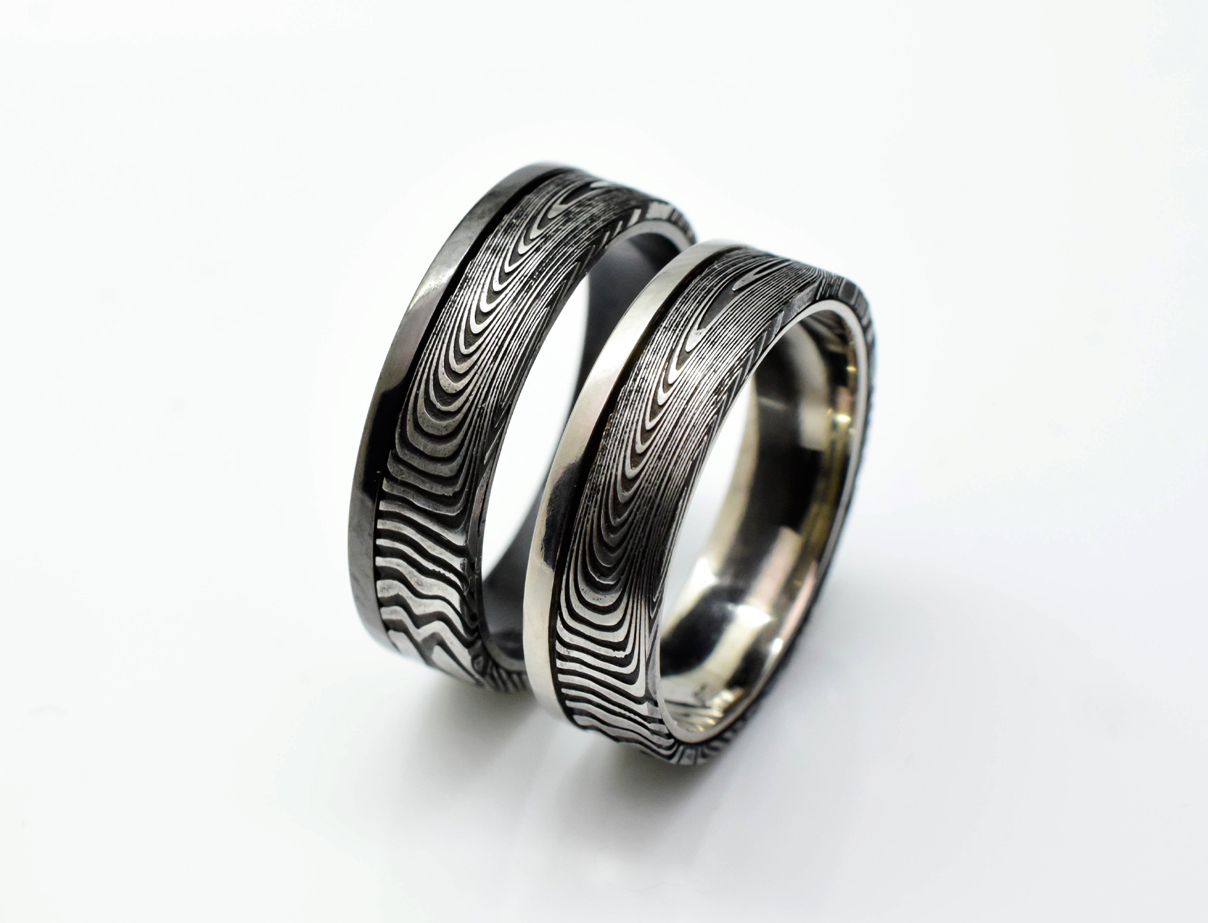 Pair of Damascus steel wedding rings with white gold