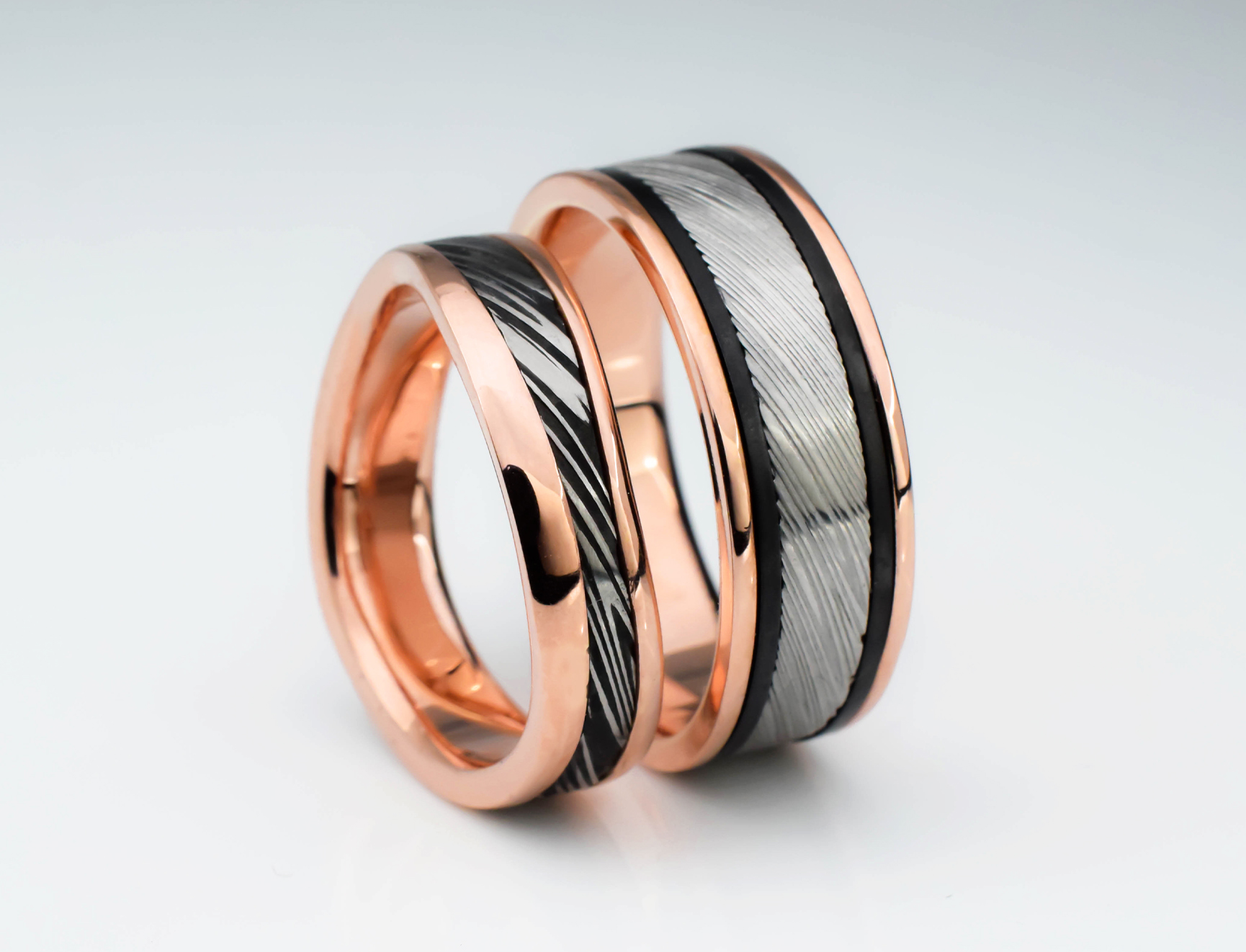 Rose gold wedding rings with Damascus steel