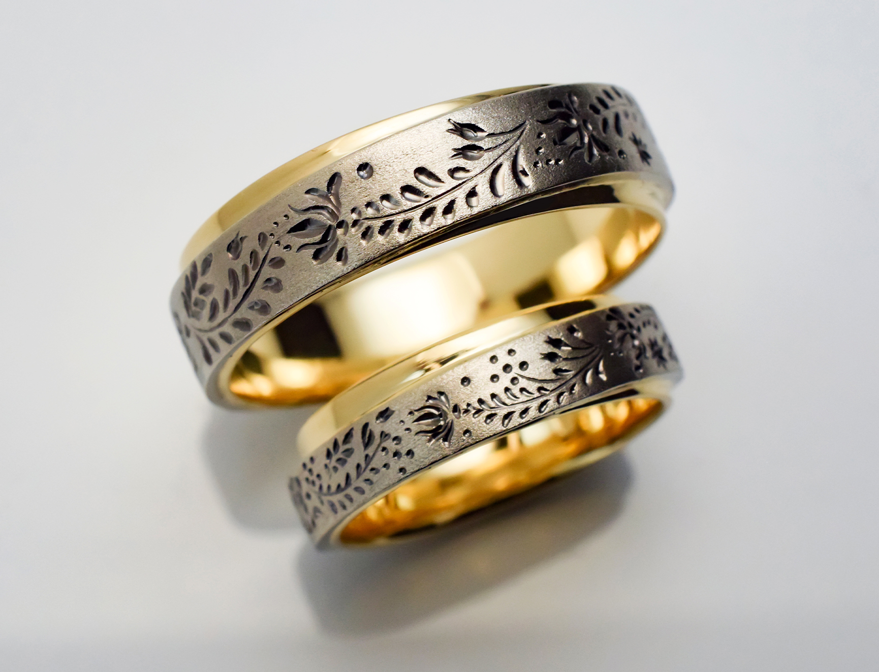 Wedding ring set in yellow and white gold with floral engraving