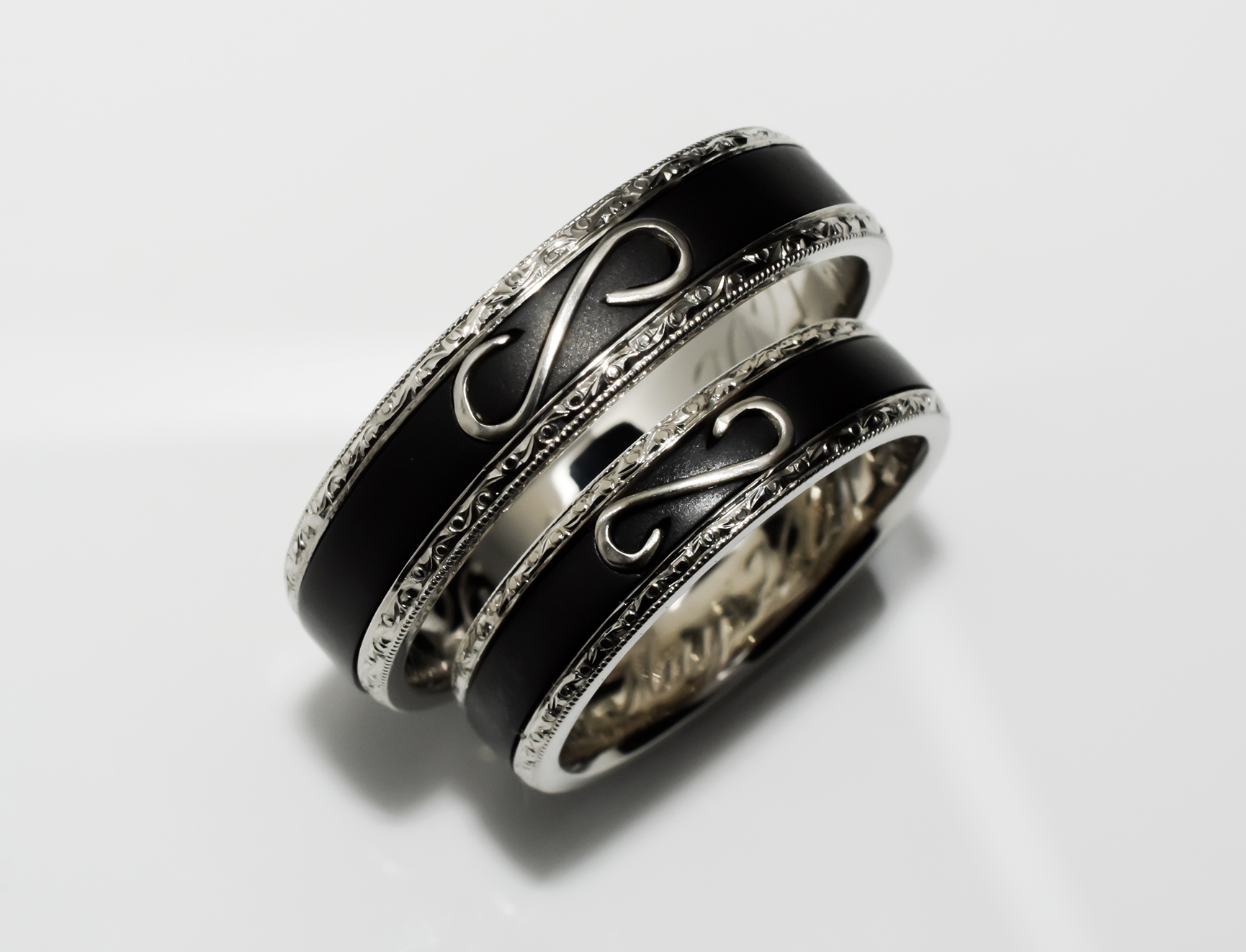 White gold wedding ring set with black enamel and engraving