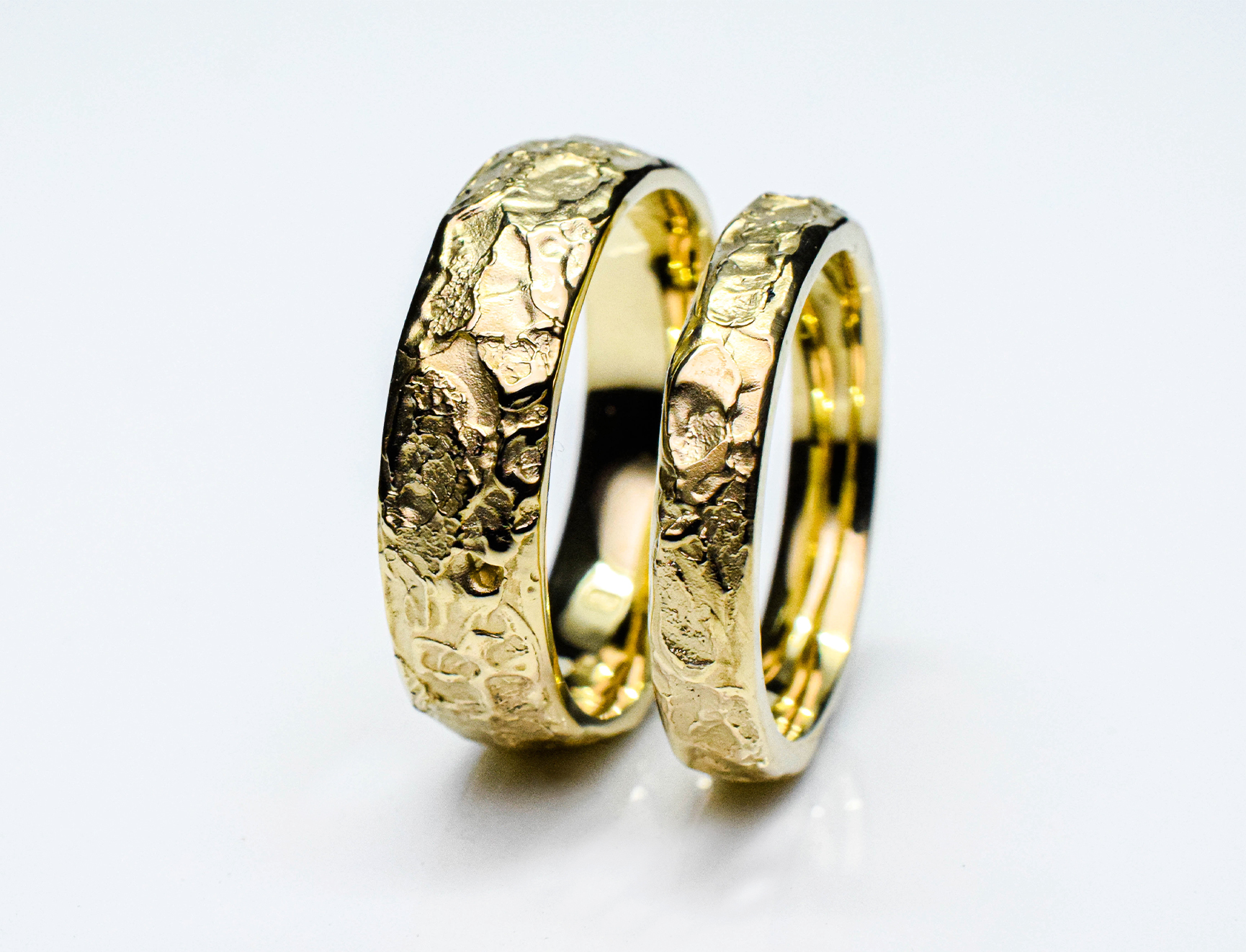Gold wedding ring set with rough texture