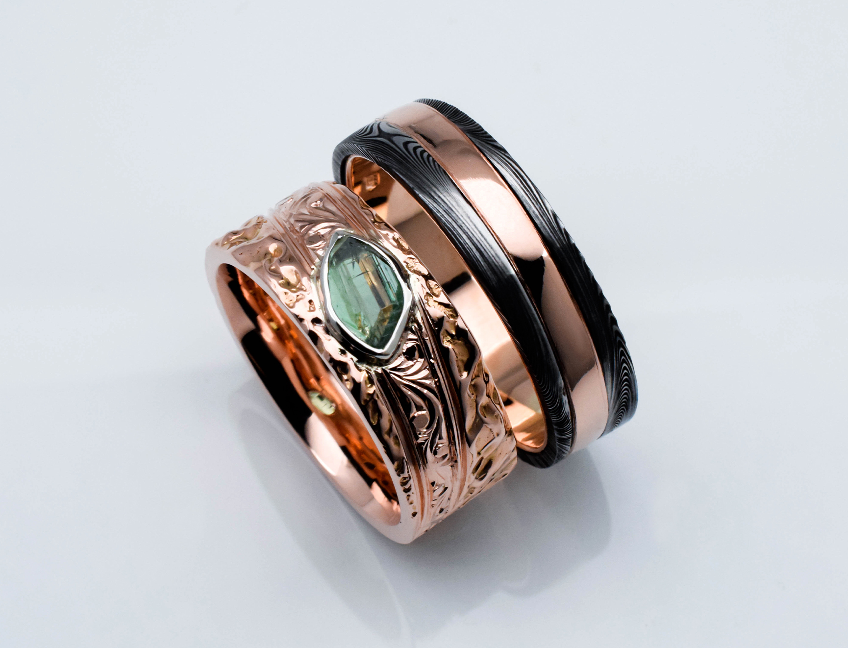 Wedding ring set in rose gold with green tourmaline and damascus