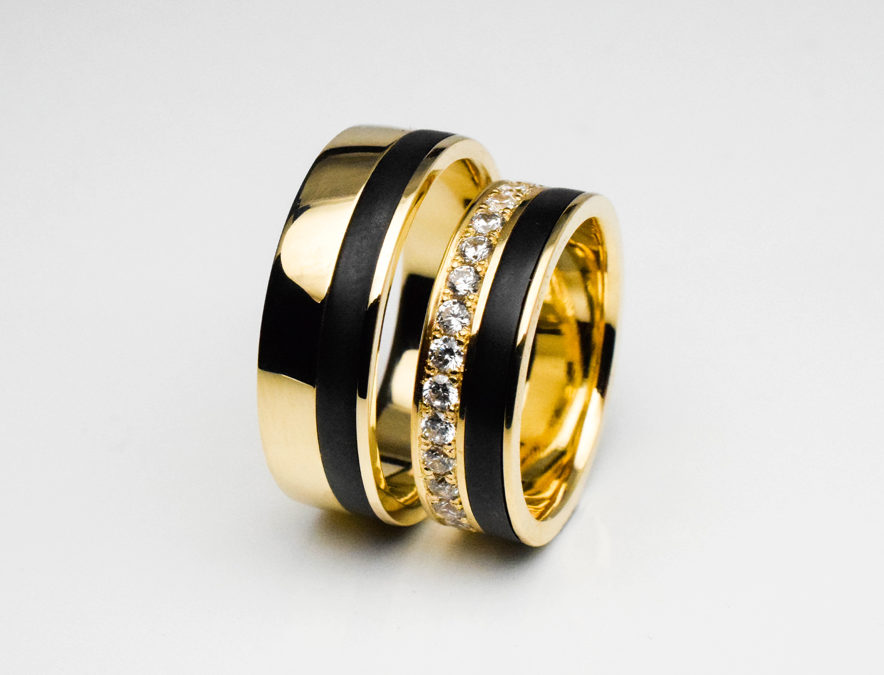 Yellow gold wedding rings with black inlay and diamonds