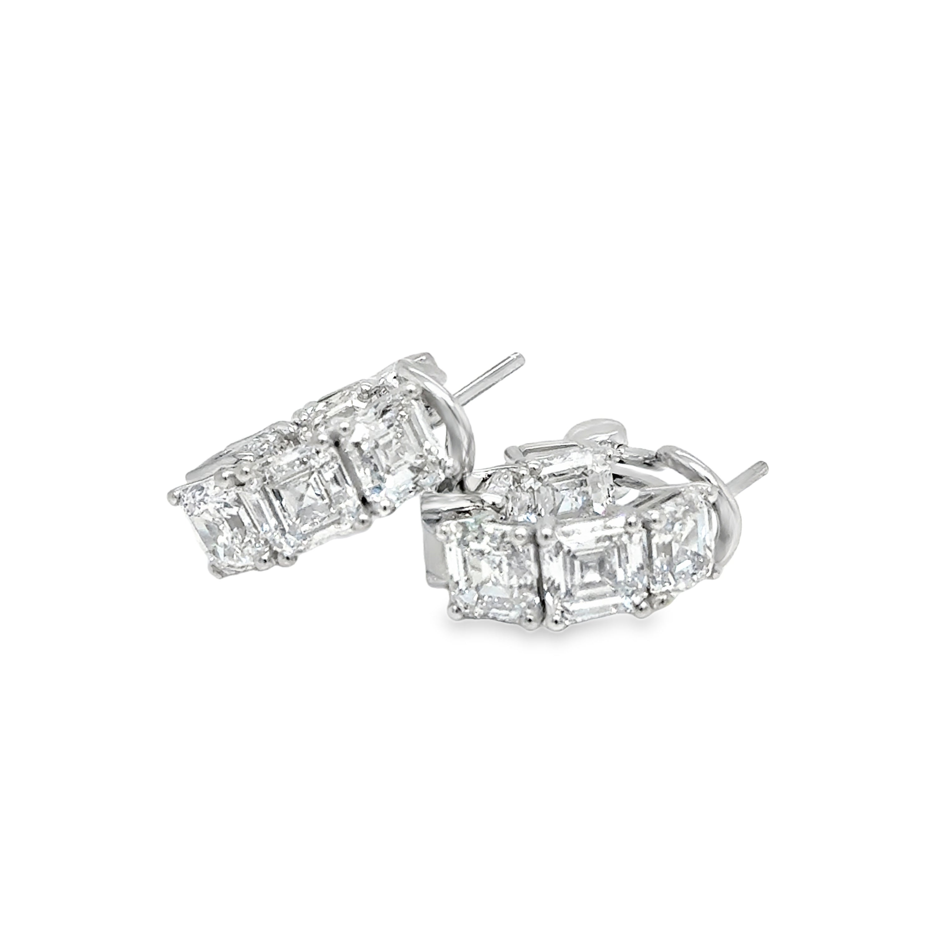 Pair of asscher cut diamond stud earrings on a white background